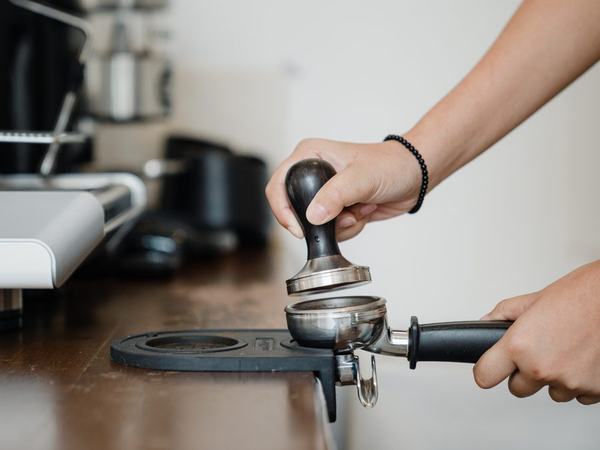 Tamping espresso into a portafilter